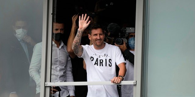 Lionel Messi waves after arriving at Le Bourget airport, north of Paris, Tuesday, Aug. 10, 2021. Lionel Messi finalized agreement on his Paris Saint-Germain contract and was flying to France on Tuesday to complete the move that confirms the end of a career-long association with Barcelona.