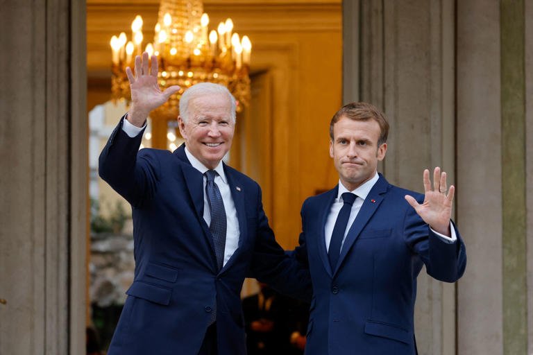 French President Emmanuel Macron (R) welcomes US President Joe Biden (L) before their meeting at the French Embassy to the Vatican in Rome on October 29, 2021.