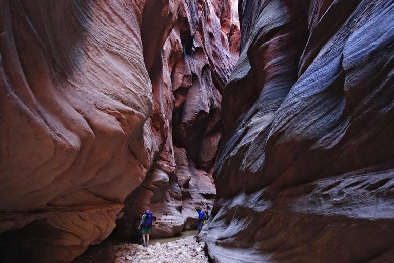 Sunlight peeks into the narrows of Buckskin Gulch in Kane County, Utah, on Sunday, Sept. 25, 2016. One man is dead and another is still missing after floodwaters poured into a slot canyon in southern Utah, endangering three groups of hikers who had to be hoisted out via helicopter Tuesday, March 14, 2023. The hikers were on a multi-day trek from Wire Pass to Lees Ferry through Buckskin Gulch's sandstone features that includes multiple narrow slot canyons. (Lennie Mahler /The Salt Lake Tribune via AP)
