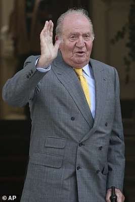 Juan Carlos I of Spain wearing a suit and tie talking on a cell phone: Juan Carlos I reigned as king of Spain from November 1975 until his abdication in June 2014