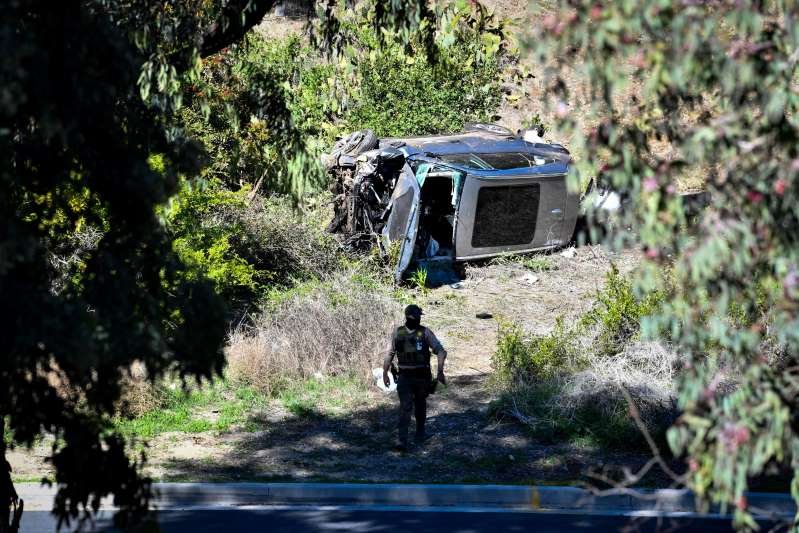 a person riding a bike down a dirt road: Tiger Woods' vehicle after he was involved in a rollover accident in Rancho Palos Verdes, California, on Feb. 23, 2021. Woods had to be extricated from the wreck by Los Angeles County firefighters, and is currently hospitalized.