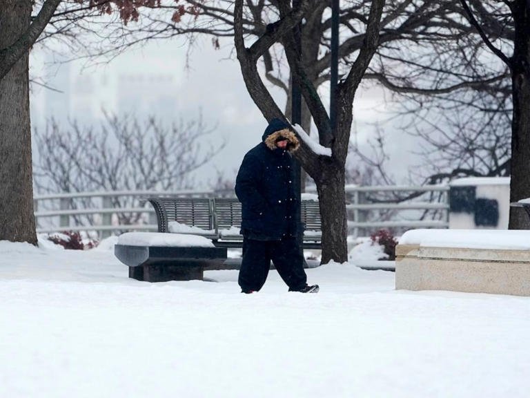 A person walks through snow on Jan. 18, 2024, in Nashville, Tenn.