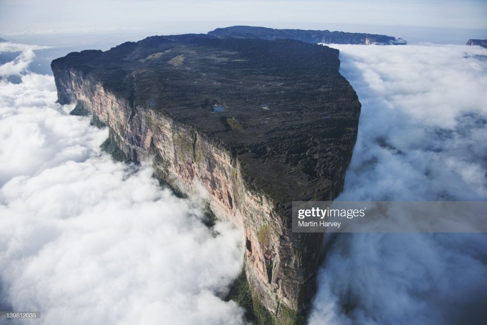 Roraima is the highest tepui reaching 2810 meters in elevation. These cloud covered flat top mountains are considered to be some of the oldest geological formations on Earth, Venezuela, South America : Stock Photo