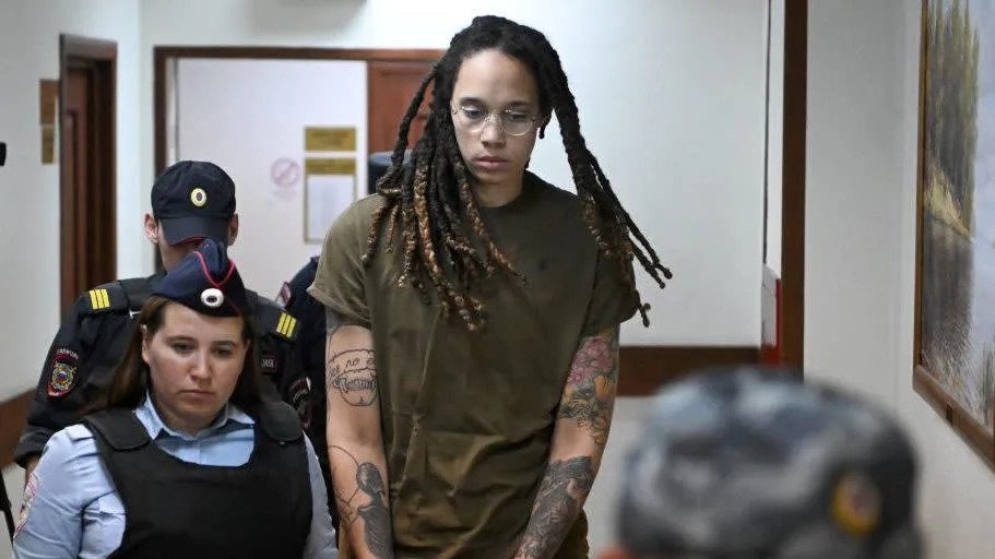 US basketball player Brittney Griner (C) is escorted by police before a hearing during her trial on charges of drug smuggling, in Khimki, outside Moscow.