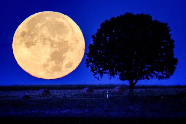 Sept. 21, 2021:  The full moon sets behind the hills of the Taunus region near Wehrheim, Germany.