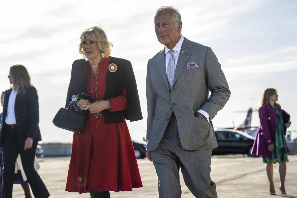Prince Charles and Camilla, Duchess of Cornwall, walk to their plane before departing Yellowknife, Northwest Territories, May 19, 2022. (Aaron Vincent Elkaim/The New York Times)